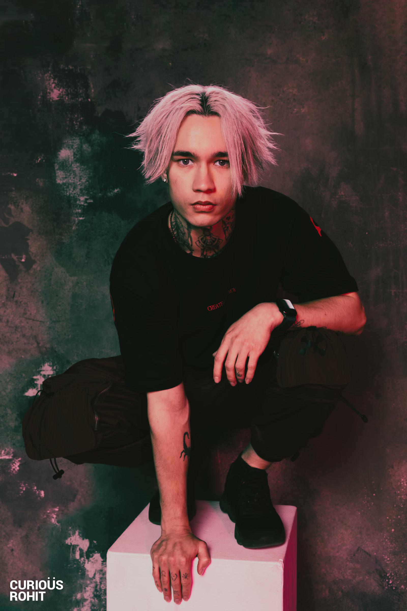 A man with blond hair kneeling down