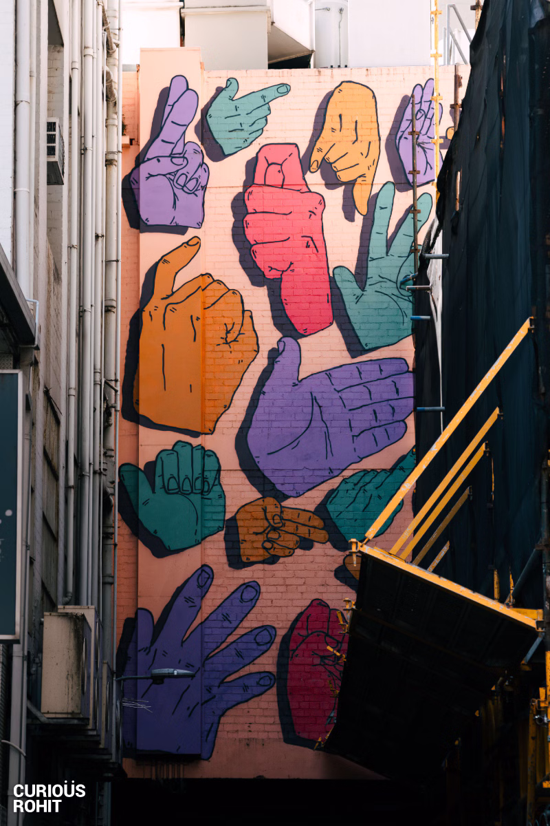 A mural of hands painted on a wall